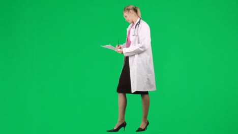 female doctor writing notes against green screen