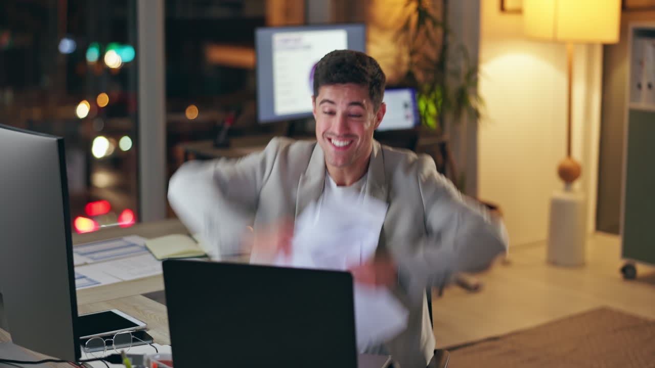 Successful businessman celebrating at his desk