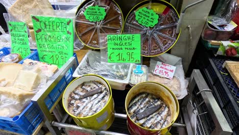 sardines displayed at a bustling market stall