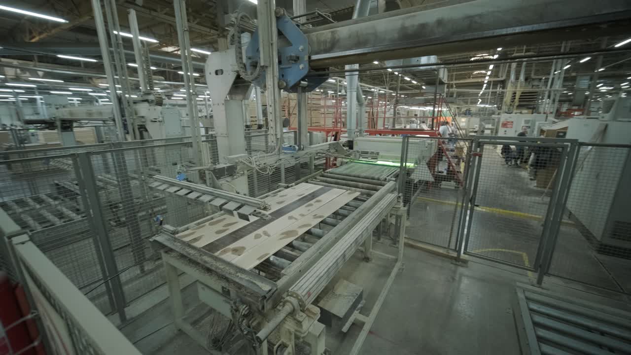 Automated Industrial Machinery Stacking Wood Panels in a Factory