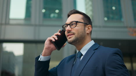 joyful french man talking mobile phone on office terrace outdoors happy smiling businessman employer ceo executive talk smartphone in city friendly business conversation cellphone call - portrait