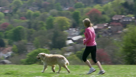 mature woman with dog jogging in countryside shot on r3d