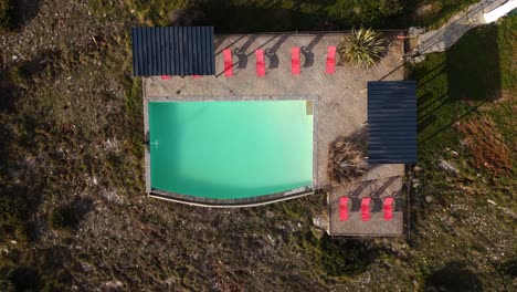 Drone-video-ascends-to-birds-eye-view-of-secluded-and-calm-pool-landscape