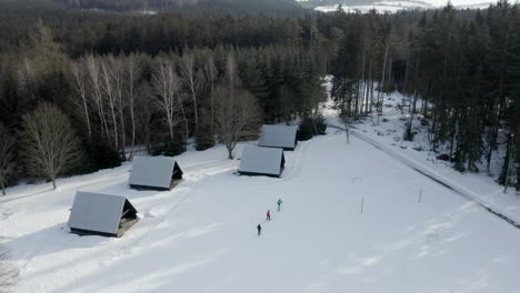 aerial shot of people skiing at a winter mountain ski camp, leisure recreational snow sport