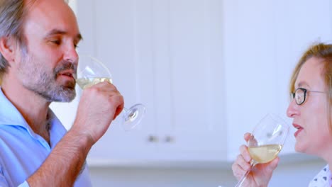 Couple-toasting-glasses-of-champagne-in-kitchen-4k