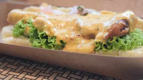 beef burger in a take away box on table