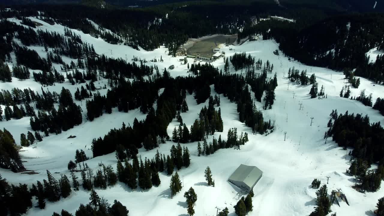 US, Oregon, Mt Hood, Meadows Ski Area, 2025-04-22 - Drone view of Mt Hood at the Mt Hood Meadows ski area in spring. Flying down the ski runs and lifts towards the lodge and parking lot.