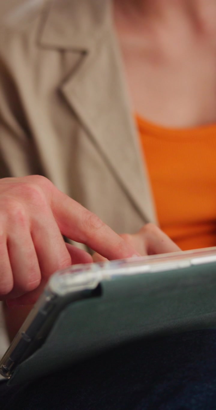 Close-up of Two People Collaborating on a Tablet