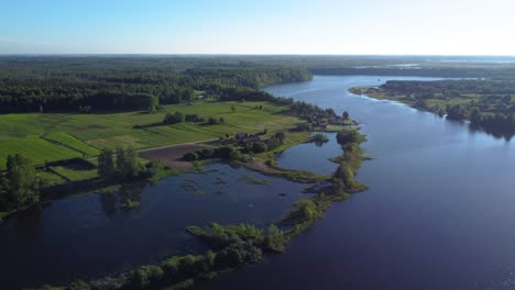 aerial fly-by over a meandering river and swampland in rural lithuania