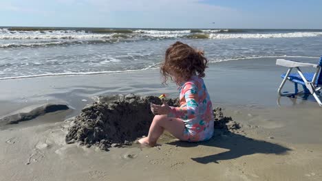 toddler building sand castle at beach kiawah island south carolina