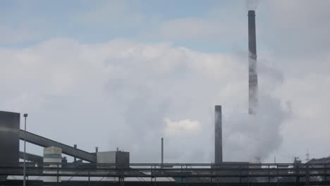 Rooftop-german-factory,-chimneys-polluting-the-air-with-smoke,-global-warming
