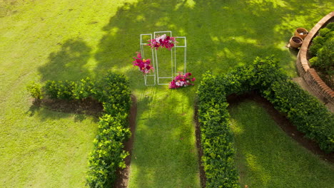 beautiful green garden wedding ceremony setup with decorated arbour, 4k drone