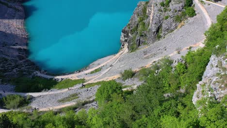 medium wide angle aerial drone shot of blue lake and surrounding landscapes in imotski during the day