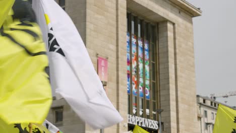 Flag-of-Vlaams-Belang-waving-among-Flags-of-Flanders-during-political-party-rally-in-Brussels,-Belgium