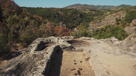 rock-cut sanctuary of harman kaya overlooking the rhodope mountain forest in bulgaria