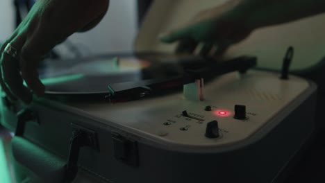 Putting-on-vinyl-record-with-hands-and-then-adjusting-volume-and-speed