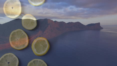 Animation of lemon slices overlaying coastal landscape with mountains and ocean