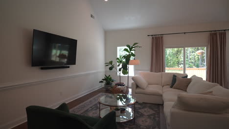 beautifully designed living room with an open concept kitchen and vaulted ceilings