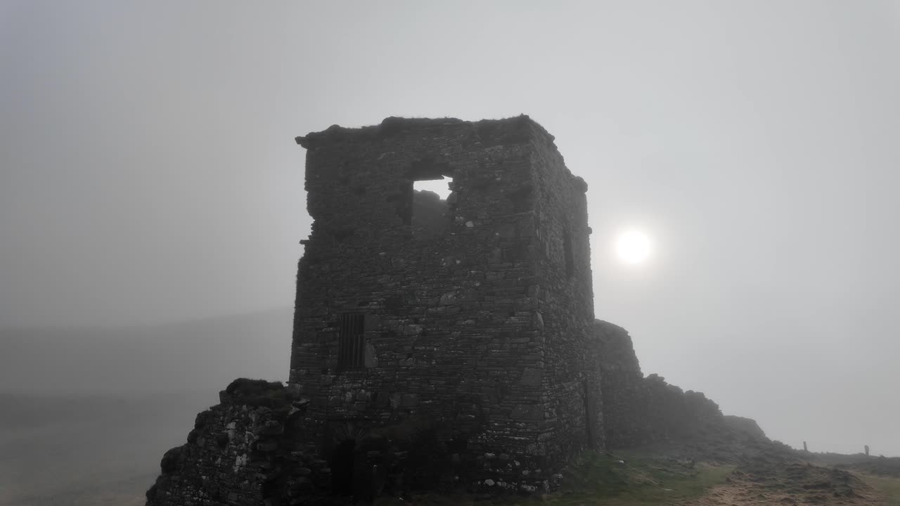 Castle in sea off haunted castle in West Cork Ireland tourist attraction on Mizen Head on a moody winter morning