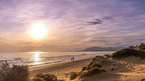 fast time lapse marbella beach sunset with people walking across the beach as the sun sets, 4k timelapse