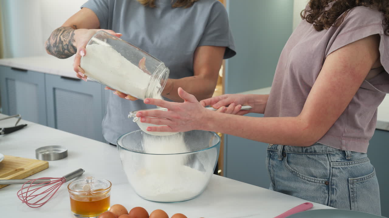 Mother and daughter baking with flour in the kitchen. Close up