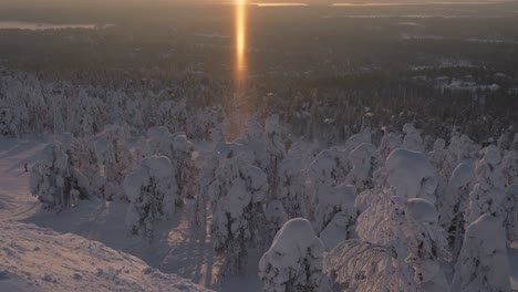 Beautiful-sunrise-over-snow-covered-forest-in-Ruka-village-in-Lapland