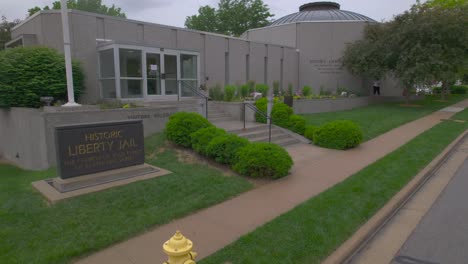 historic liberty jail sign in front of a mormon visitor center in liberty missouri