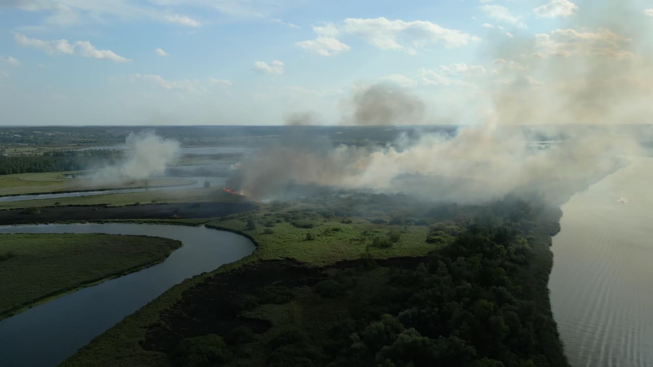 Aerial View of Wildfire Burning Near a River
