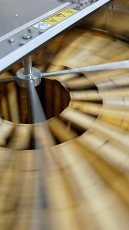 honey pumping. centrifuge device that spinning honey from honey cells. honey extractor is orbiting with frames with honeycombs. getting honey from honeycomb. vertical video