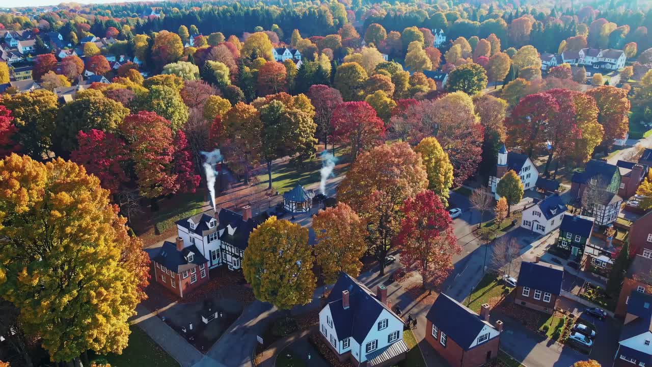 Video showcasing a serene neighborhood in autumn, with vibrant foliage and charming houses