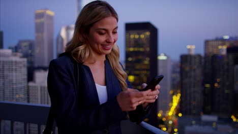 caucasian american businesswoman using smartphone technology on rooftop