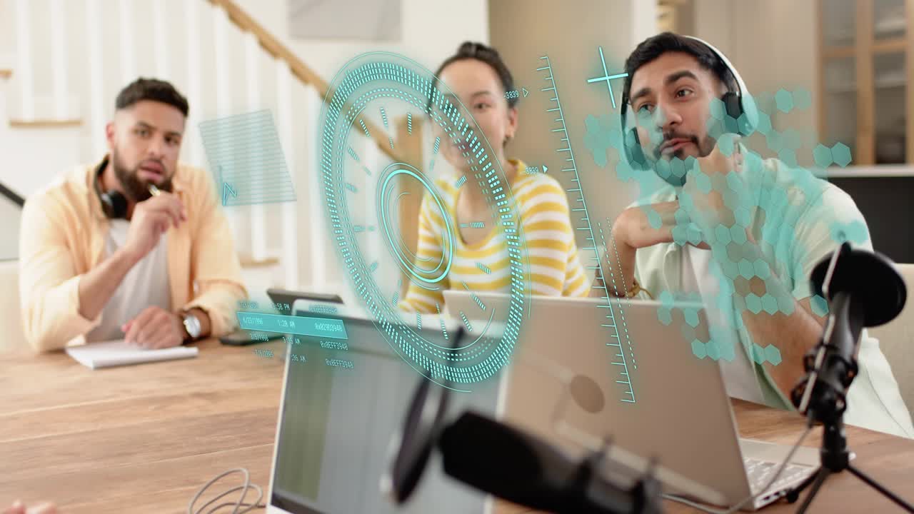 Creative team meeting reacting to teal holographic UI appearing, gesturing, taking notes on laptops