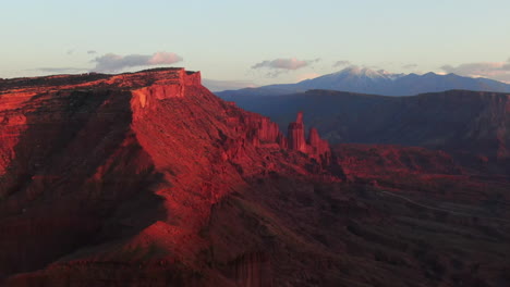 aerial cinematográfico drone dramático moab utah naranja rojo puesta de sol montaña pico de nieve gran enchilada paisaje arcos parque nacional castle valley castleton pescadores torre acampada río colorado movimiento hacia atrás