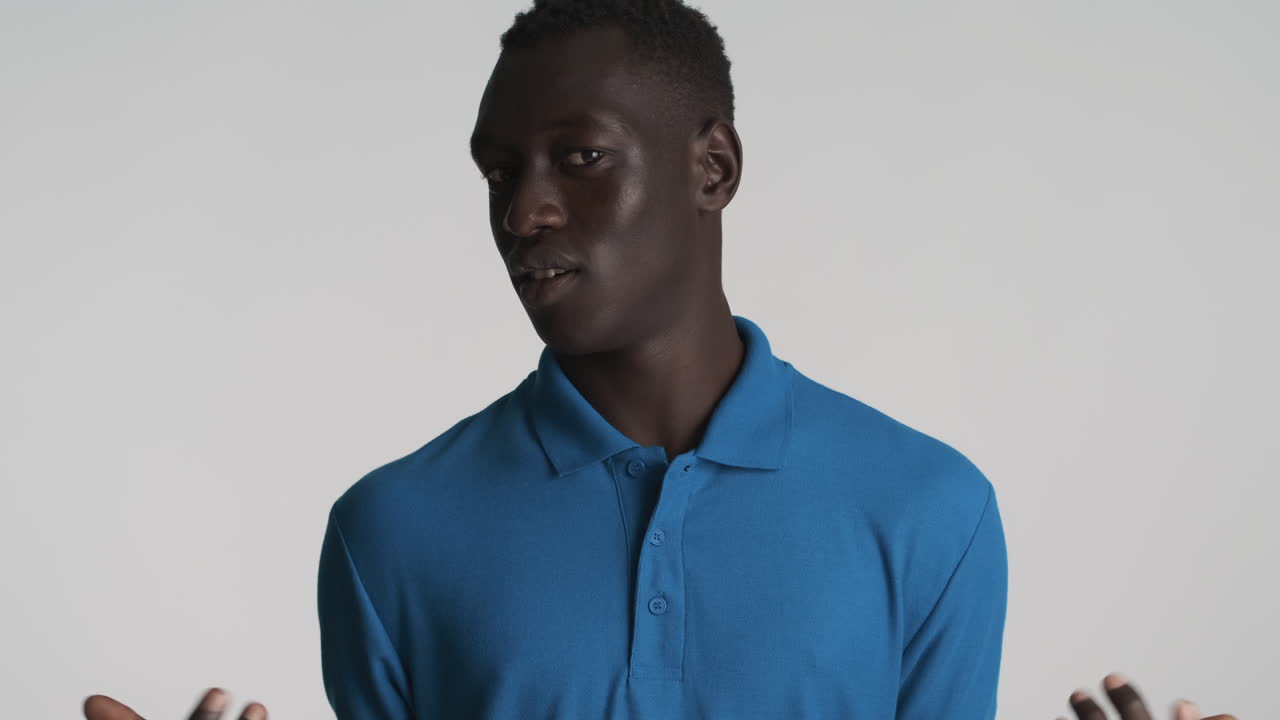 Indignant African american man on grey background.