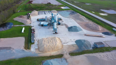 asphalt production machinery and material piles in detailed aerial view