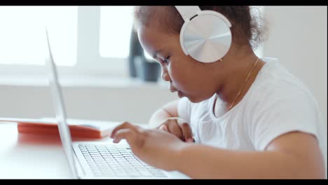 young girl learning on laptop