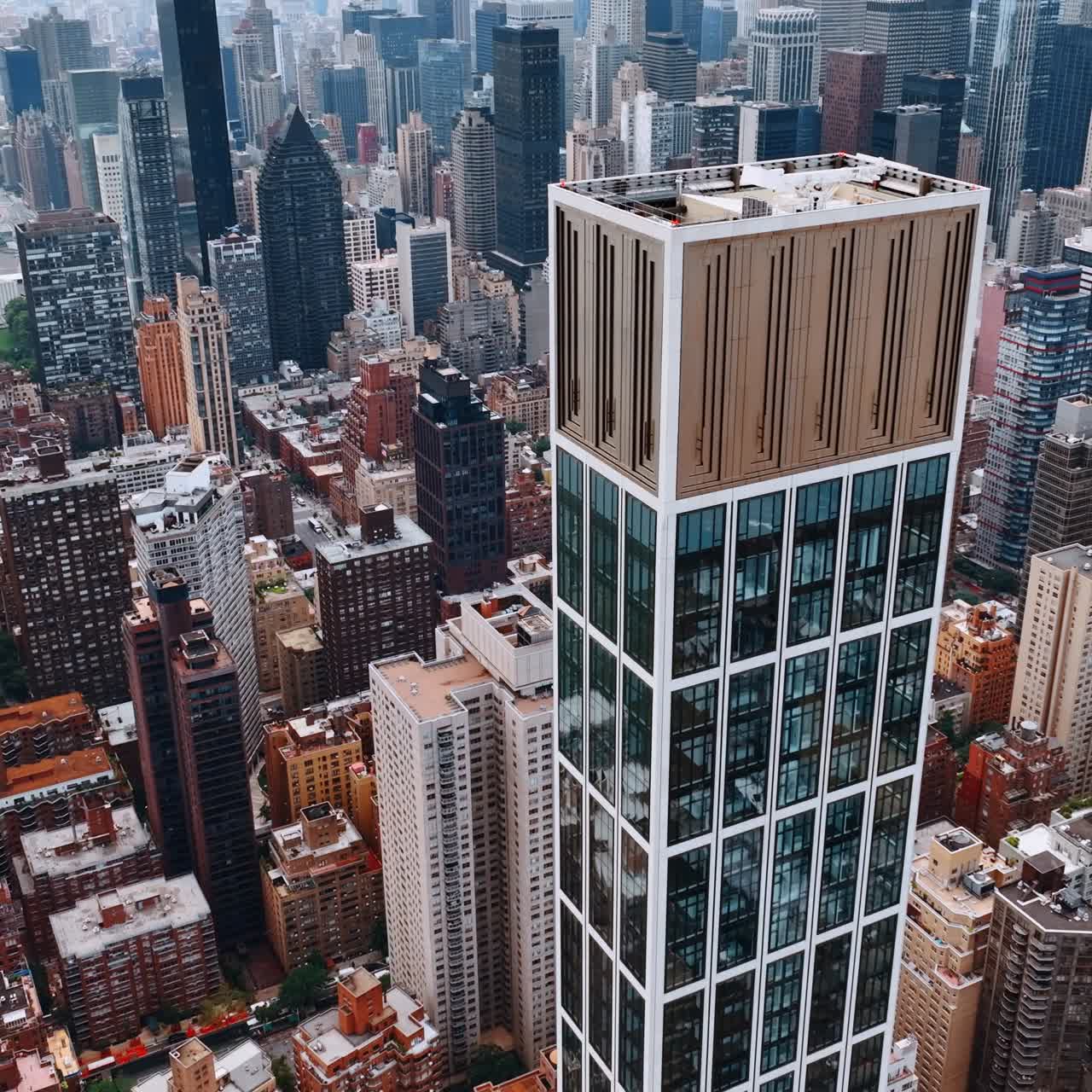 Gorgeous skyscrapers overpeer above the city panorama. Breath-taking view of New York at daytime from top