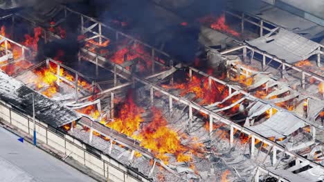 telephoto aerial of fire ravaging textile factory in santo domingo industrial