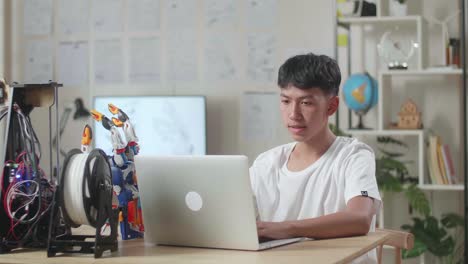 teenager working on a laptop in a tech-focused environment