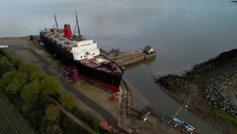 TSS-Duke-of-Lancaster-abandoned-railway-steamer-ship-docked-in-Mostyn-Docks---aerial-drone-shot