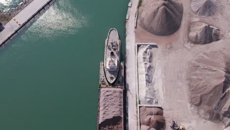 aerial view of heavy machinery working at gravel pit in kingsville with pelee island ferry service in ontario, canada