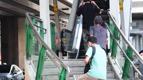 people climbing stairs at a busy transit hub