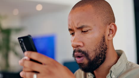 man looking at his smartphone with a worried expression