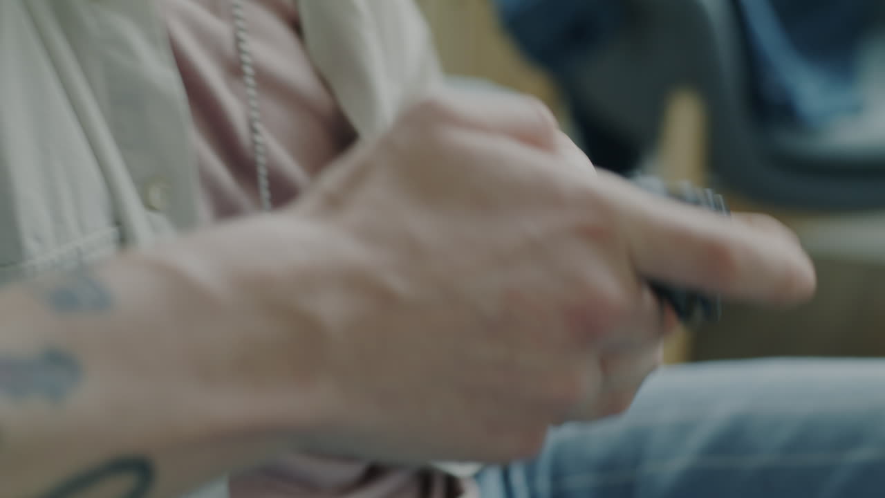 Person Playing Video Game and Another Person