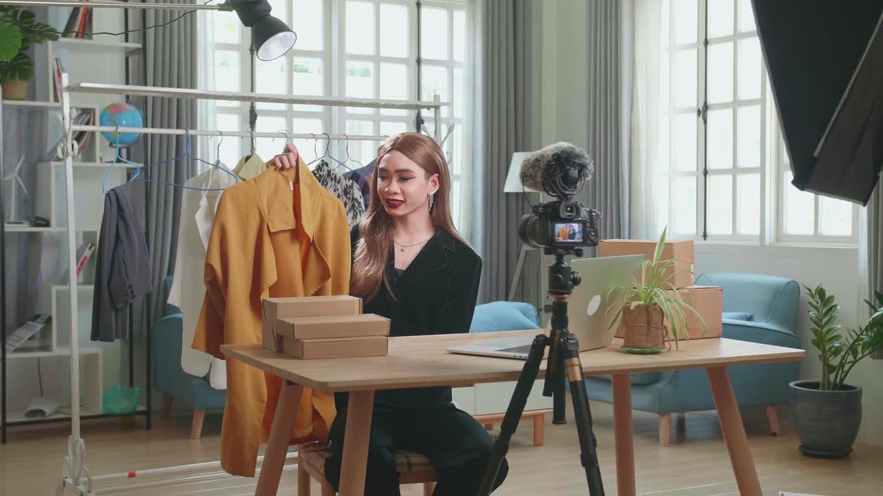 Fashion Blogger Transgender Woman Showing Casual Colorful Shirts On Camera. Stylist Influencer Shemale Showing Trendy Clothes Filming Vlog Episode