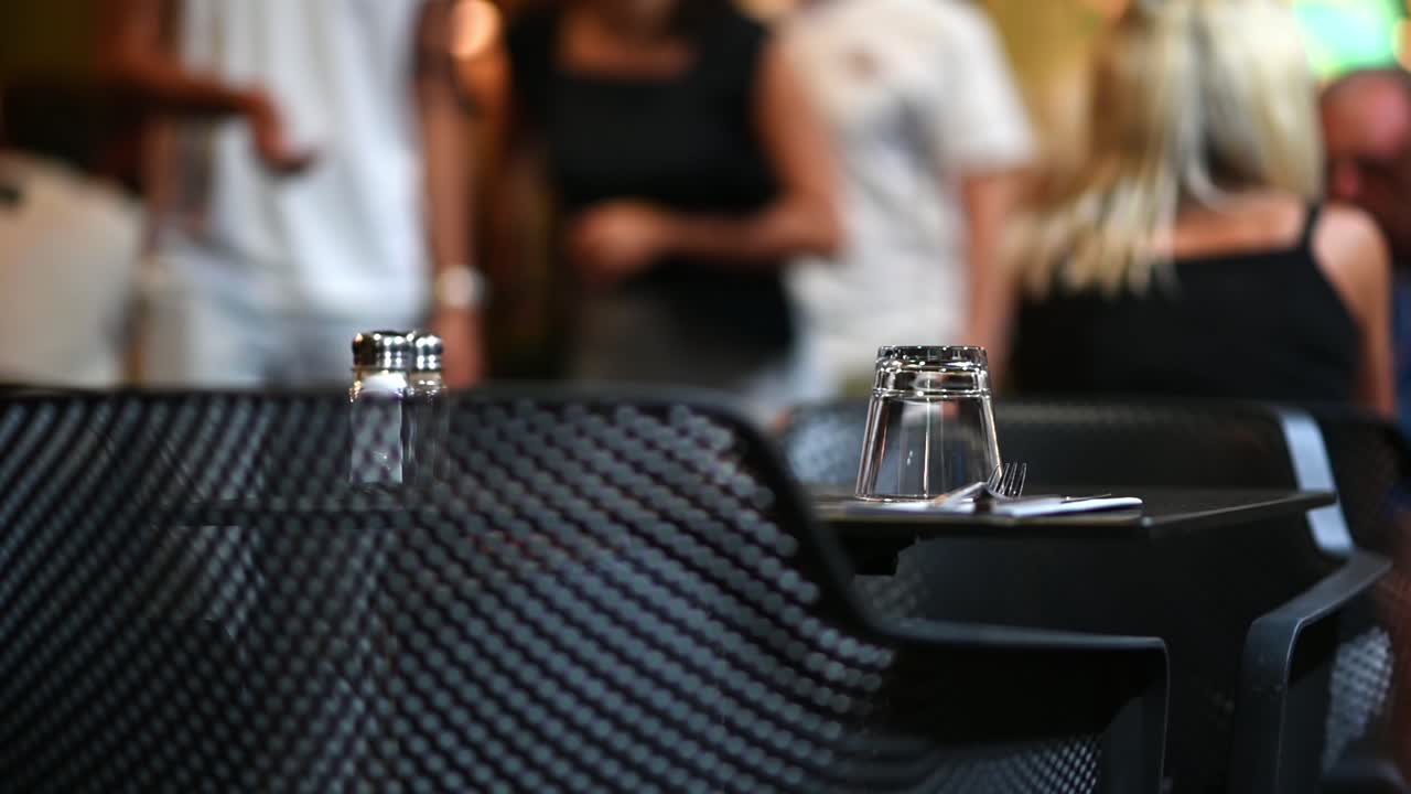 Restaurant table with settings and people in background