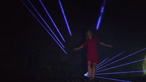 great slow motion cinematic of a girl danzing alone in the dark in front of a laser at party festival in a russian shooting range foto video shoot on lost places in nature 1080, 24p by philipp marnitz