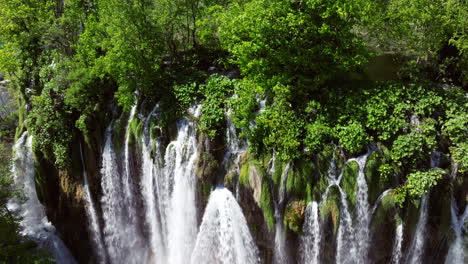 fresh water flowing on the waterfalls at plitvice lakes national park in croatia. - aerial shot