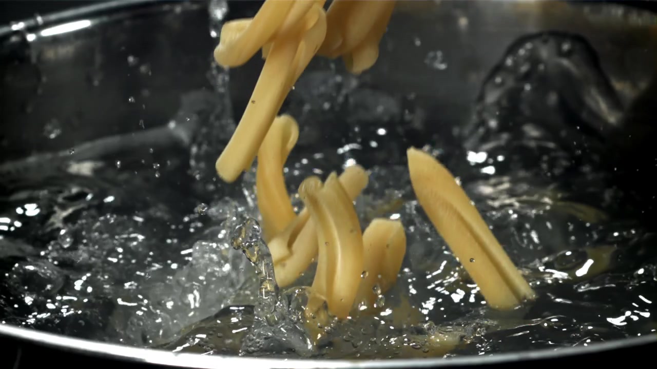 Slow Motion of Pasta Dropping into Boiling Water