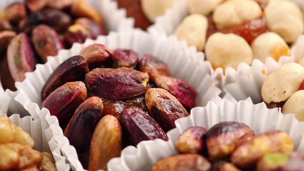 Close-up of Assorted Gourmet Nut Sweets in Paper Cups